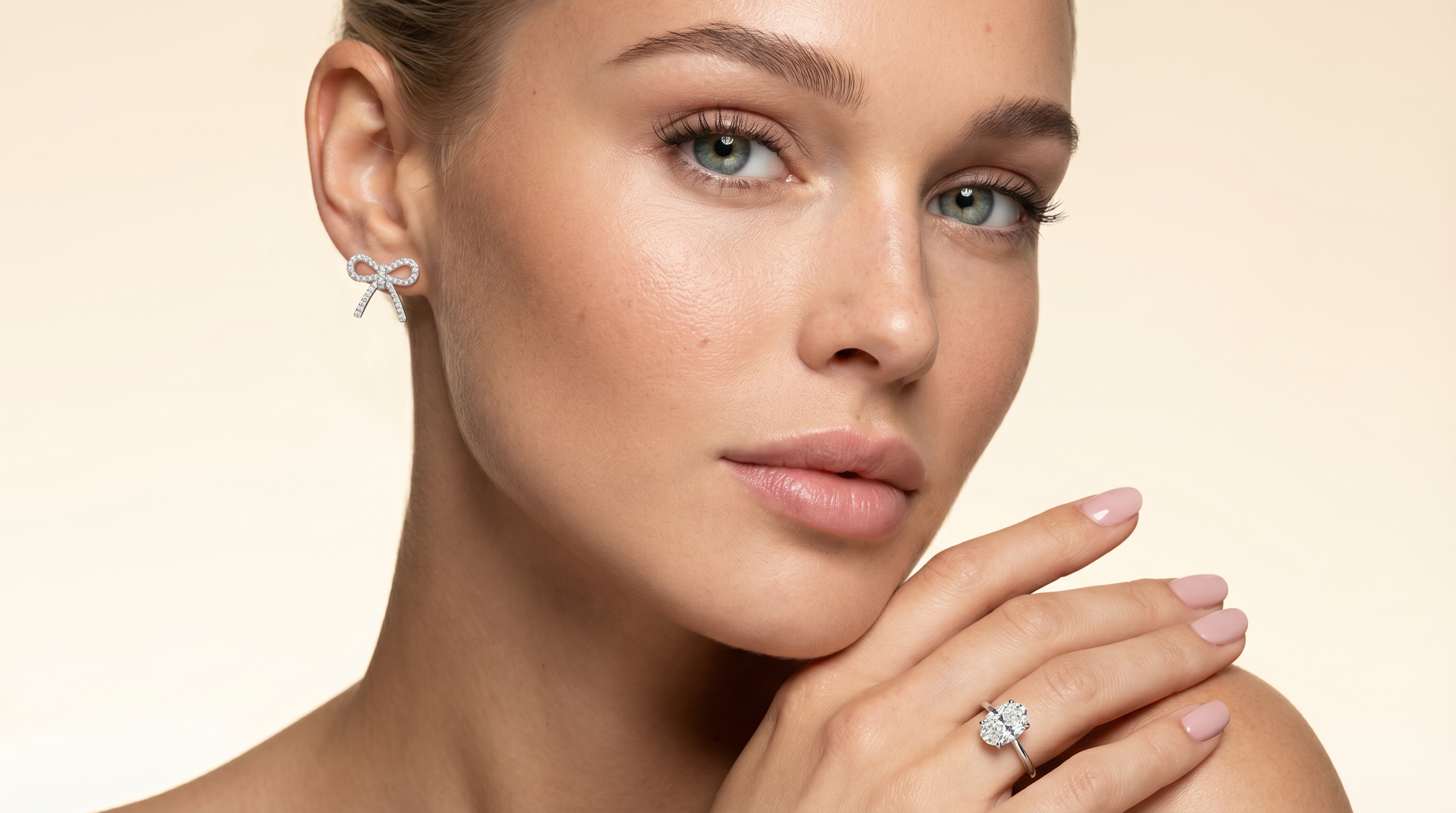 Ribbon earring on model and oval diamond engagement ring 