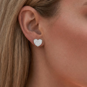 Model wearing Esmeé pavé heart diamond earrings in 18k white gold with traceable natural diamonds.