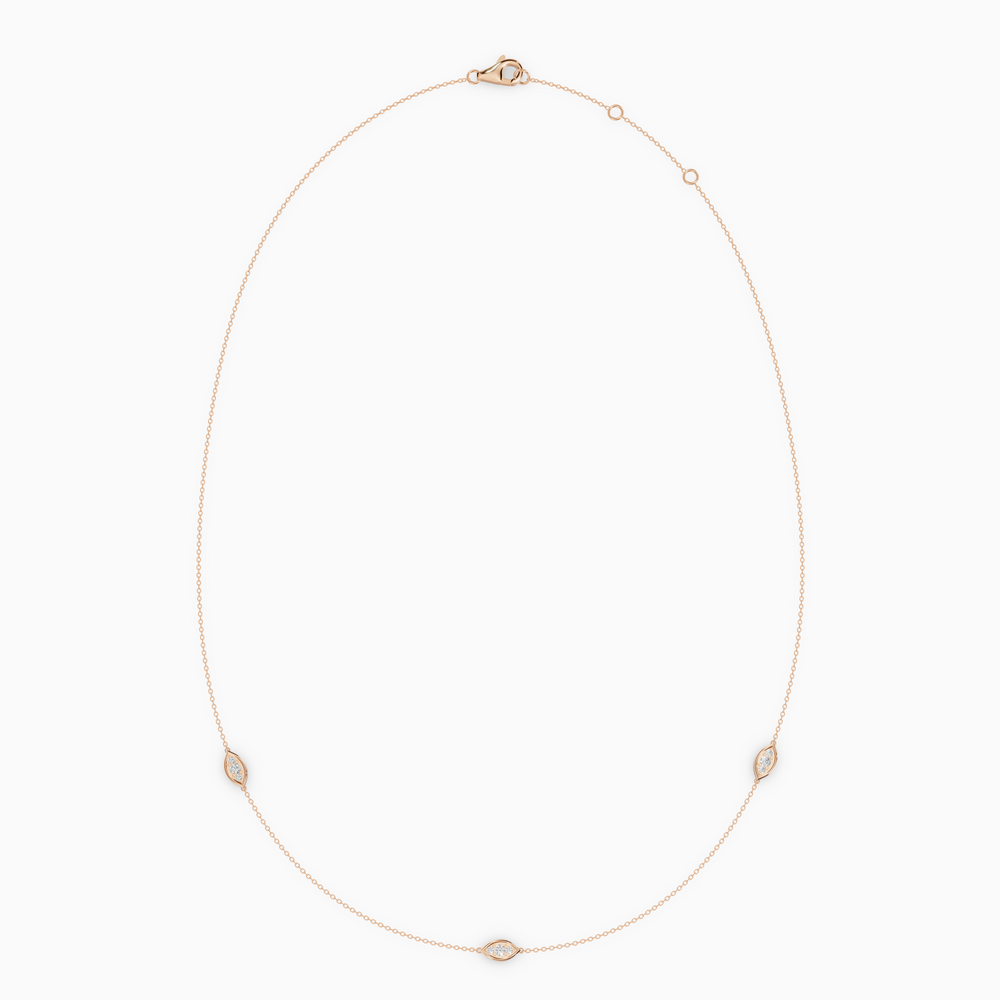 Delicate necklace in rose gold featuring three evil eye–shaped diamond elements spaced along a fine chain, with an adjustable clasp.