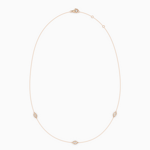 Delicate necklace in rose gold featuring three evil eye–shaped diamond elements spaced along a fine chain, with an adjustable clasp.