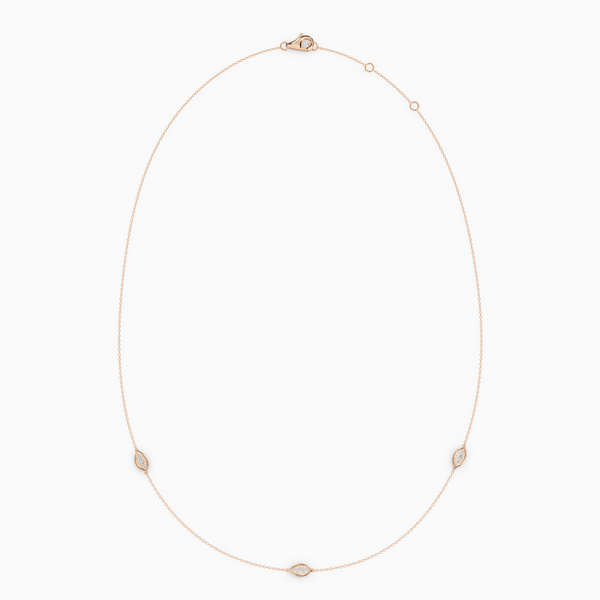 Delicate necklace in rose gold featuring three evil eye–shaped diamond elements spaced along a fine chain, with an adjustable clasp.