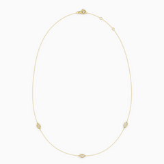 Delicate necklace in yellow gold featuring three evil eye–shaped diamond elements spaced along a fine chain, with an adjustable clasp.