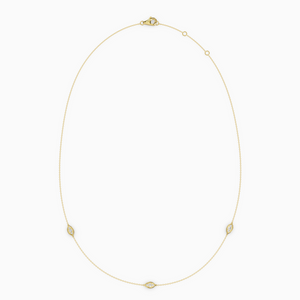 Delicate necklace in yellow gold featuring three evil eye–shaped diamond elements spaced along a fine chain, with an adjustable clasp.