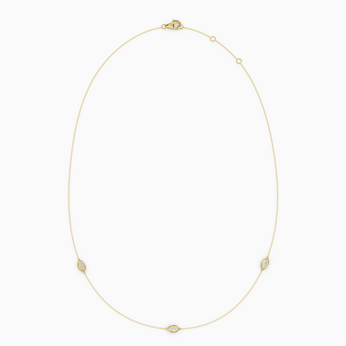 Delicate necklace in yellow gold featuring three evil eye–shaped diamond elements spaced along a fine chain, with an adjustable clasp.