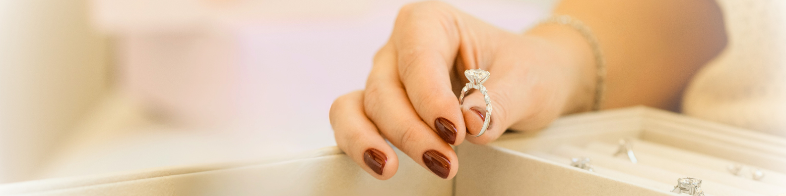 Hand holding a natural diamond engagement ring from CAREDIAMONDS – showcasing refined craftsmanship, brilliance, and timeless responsible luxury.