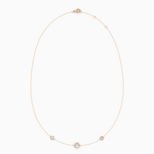 PURE diamond necklace in rose gold with bezel-set natural diamonds, delicate fine chain with slightly larger center stone.
