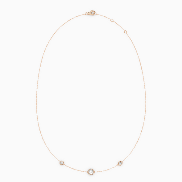 PURE diamond necklace in rose gold with bezel-set natural diamonds, delicate fine chain with slightly larger center stone.