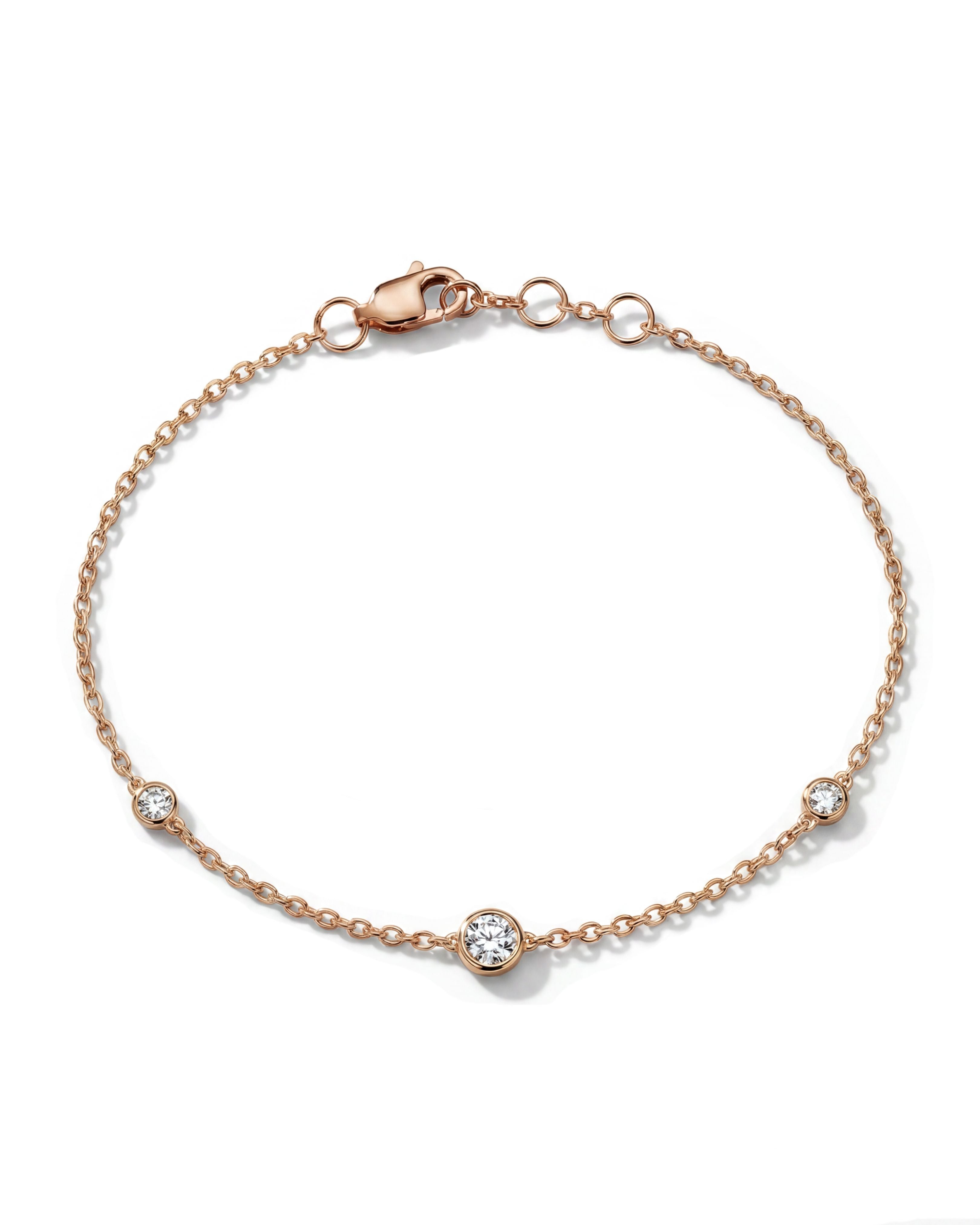 Thin fine jewelry bracelet with bezel diamonds in rose gold. 
